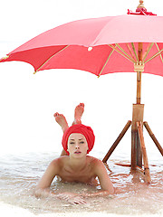 Two nude fashion models posing on the beach