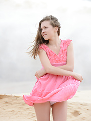 Delicious teen bombshell taking off clothes and showing wonderful naked body in the sands.