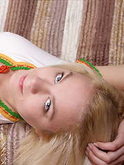 Amazing blonde sweetie undressing and showing off her tempting slender body on the couch.
