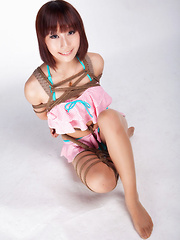 Ayako Asian leering babe has big smile on face as is tied in rope