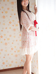 Mayumi Yamanaka Asian smiles while undressing with erotic moves